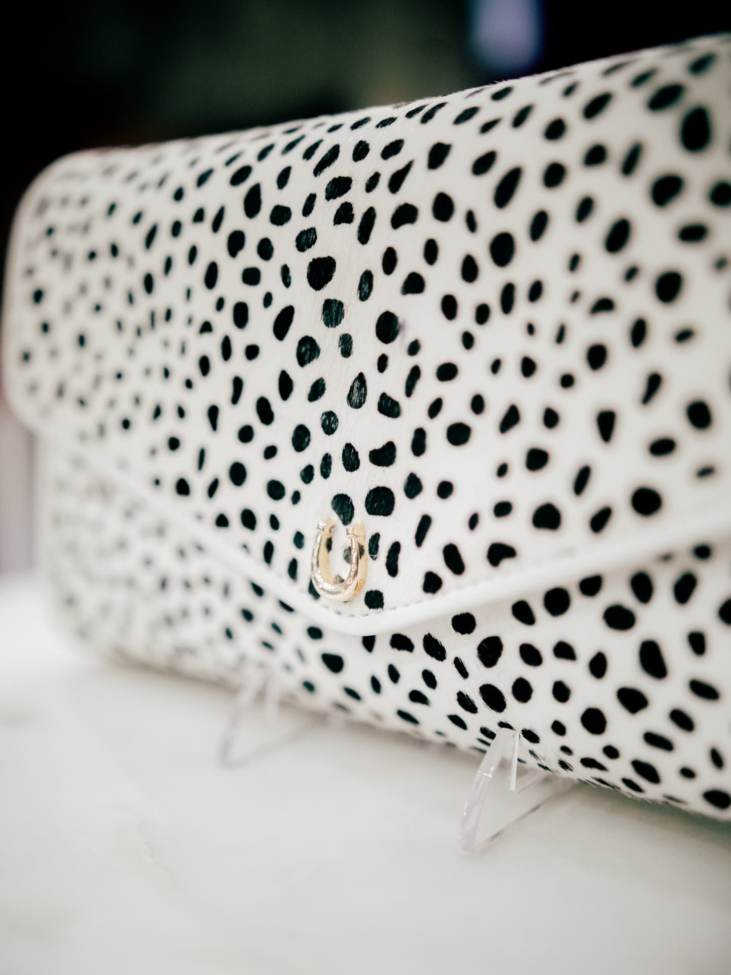 The Cruella black-and-white horsehair clutch with gold chain
